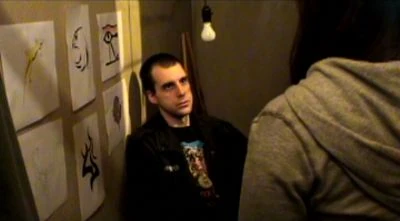 Howard (Bryan McWhirter) listens to the unusual tattoo request of a young woman in Lazarus (2006).