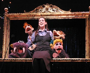 Anne Hathaway and the puppet cast of Carnival