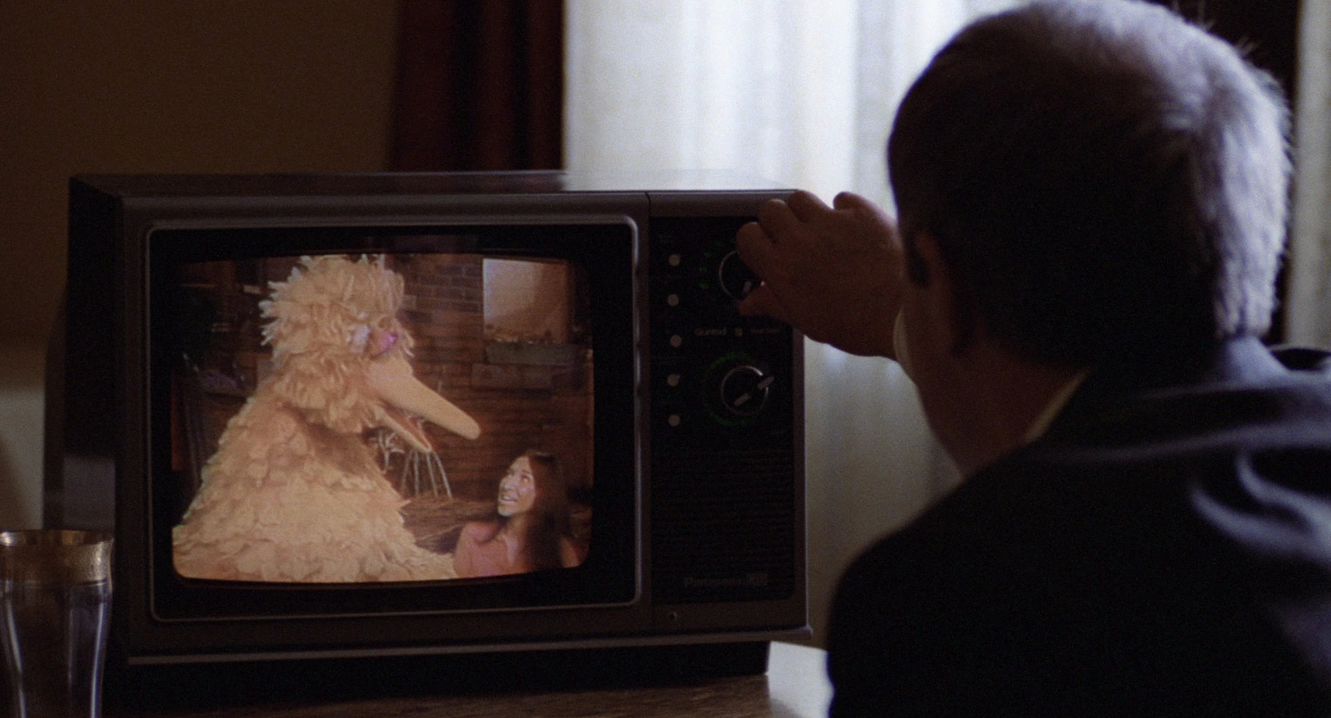 Chance watches a scene with Big Bird and Buffy.
