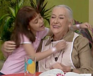 La Abuela (Beatriz Aguirre) receives affection from a young neighbor