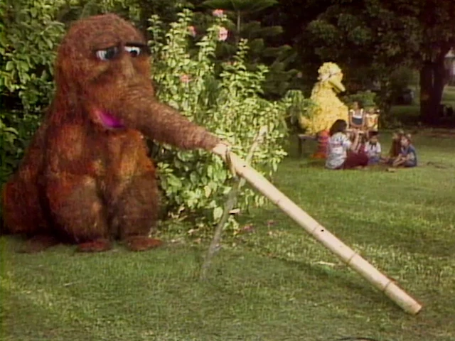 A Snuffleupagus uses his snuffle to play the nose flute