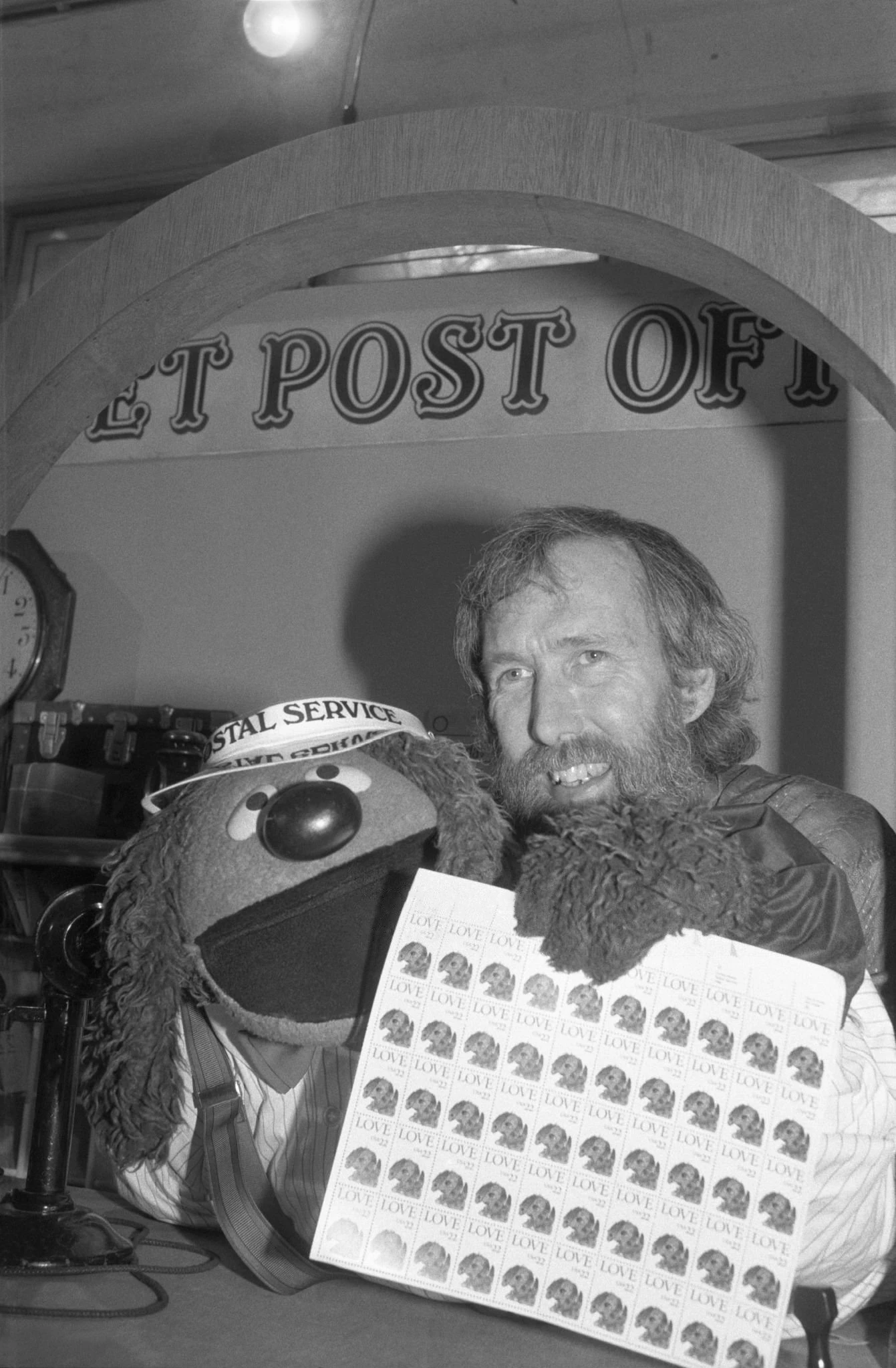Jim Henson and Rowlf with a sheet of Love Stamps, 1986