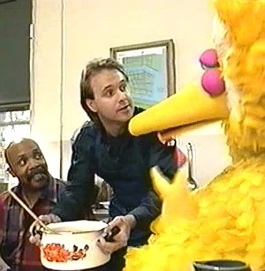 Fireman Greg Lee serving stew to Big Bird