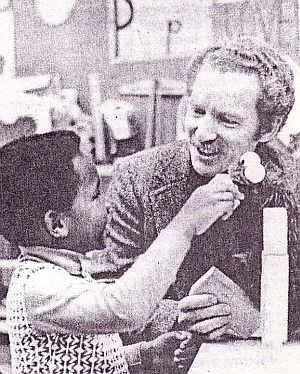 Edward L. Palmer and Cookie Monster play with a five year-old in 1975