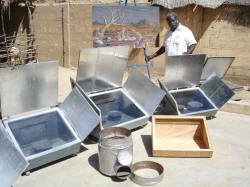 Gnibouwa Diassana with several of his solar box cookers